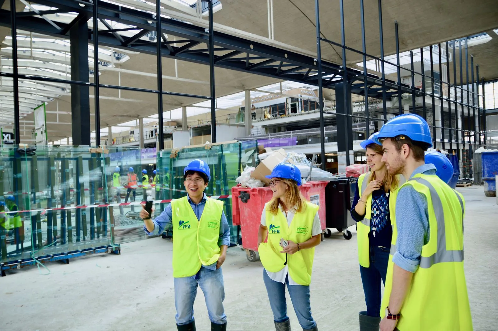 Construction team coordinating plans at an active site